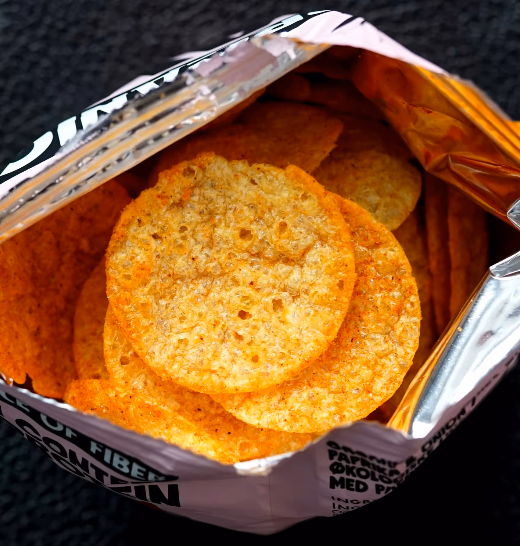 Close-up view of POTATO SHOP baked potato tenis inside an open bag.